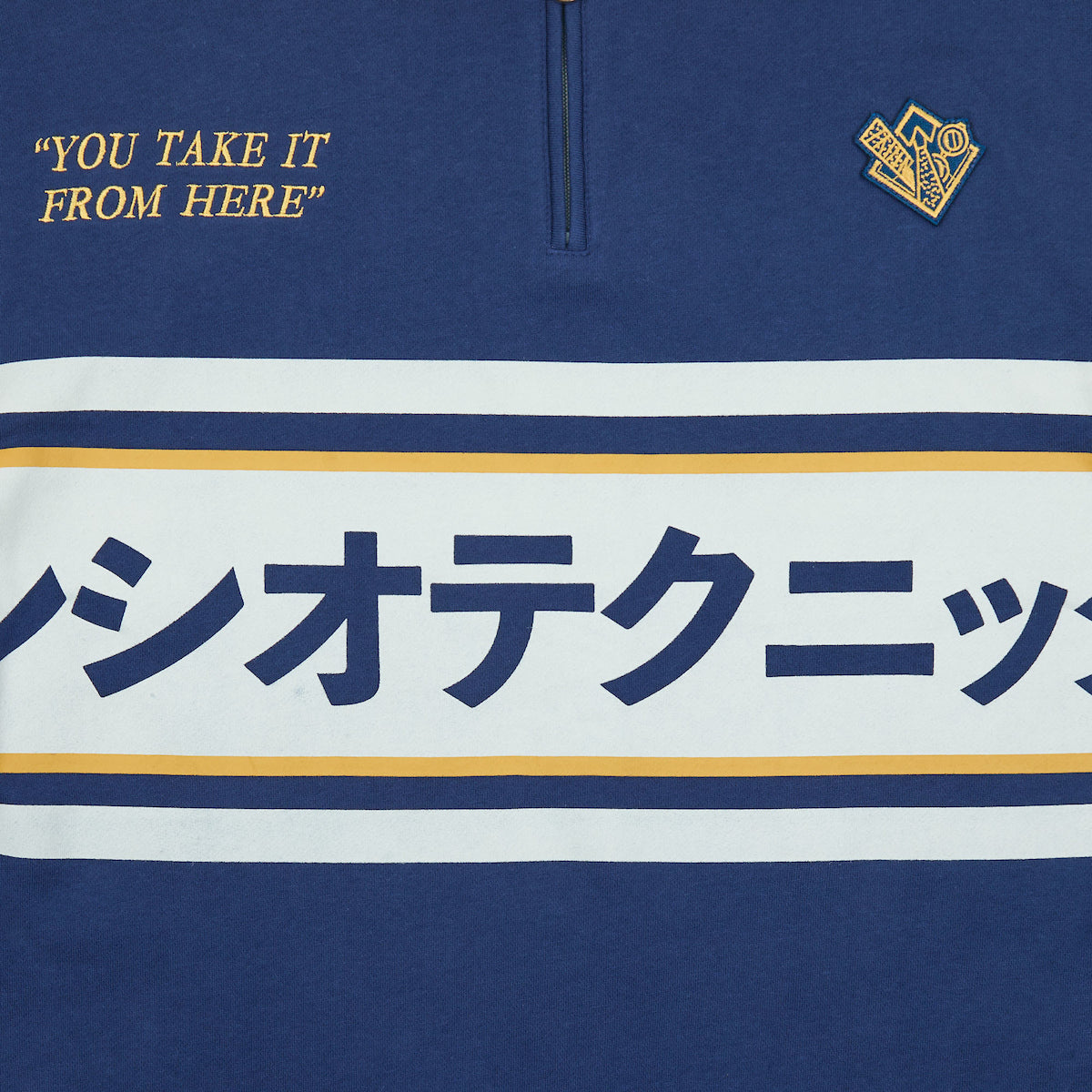 Close-up of the Kanji across the front chest of Atsuko Kento Nanami Blue & Yellow Quarter-Zip Pullover.